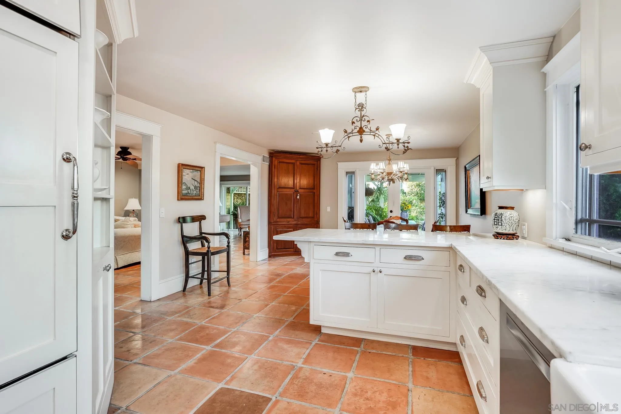 2 The Inlet Coronado, CA 92118 - Photo 8 of 40 a large white kitchen with a sink and chandelier