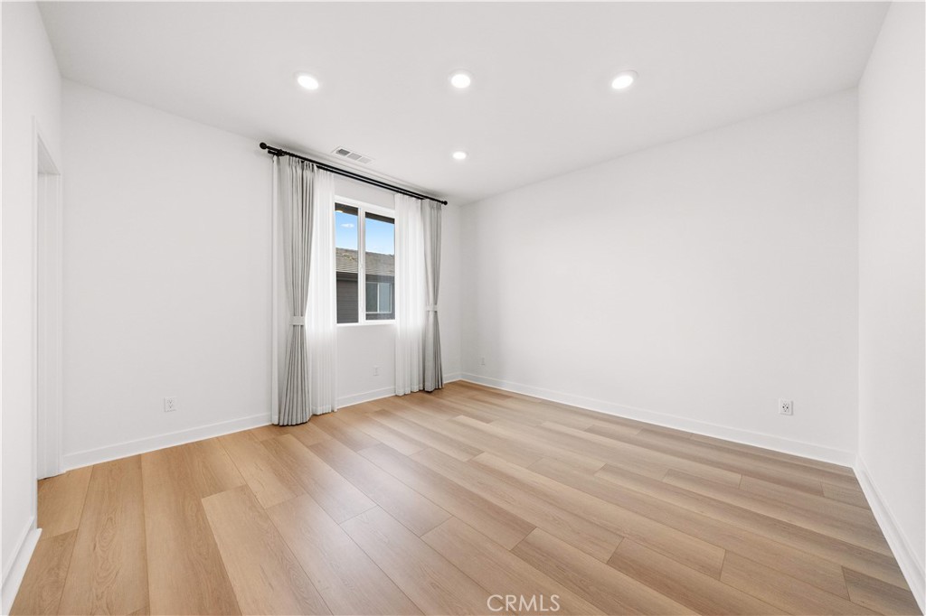 312 Tank Irvine, CA 92618 - Photo 32 of 75 a view of an empty room with wooden floor and a window
