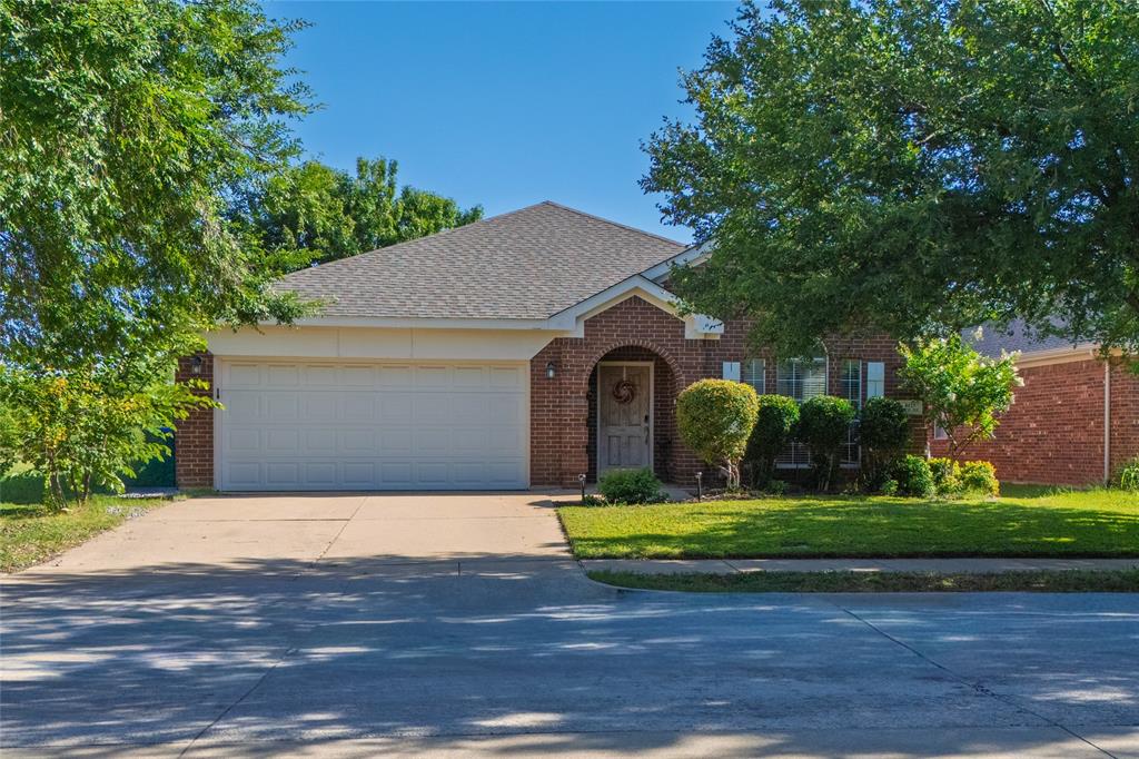 4025 Chisos Rim Trail Fort Worth, TX 76244 - Photo 2 of 40 Brick exterior featuring a gabled roof and an arched entryway