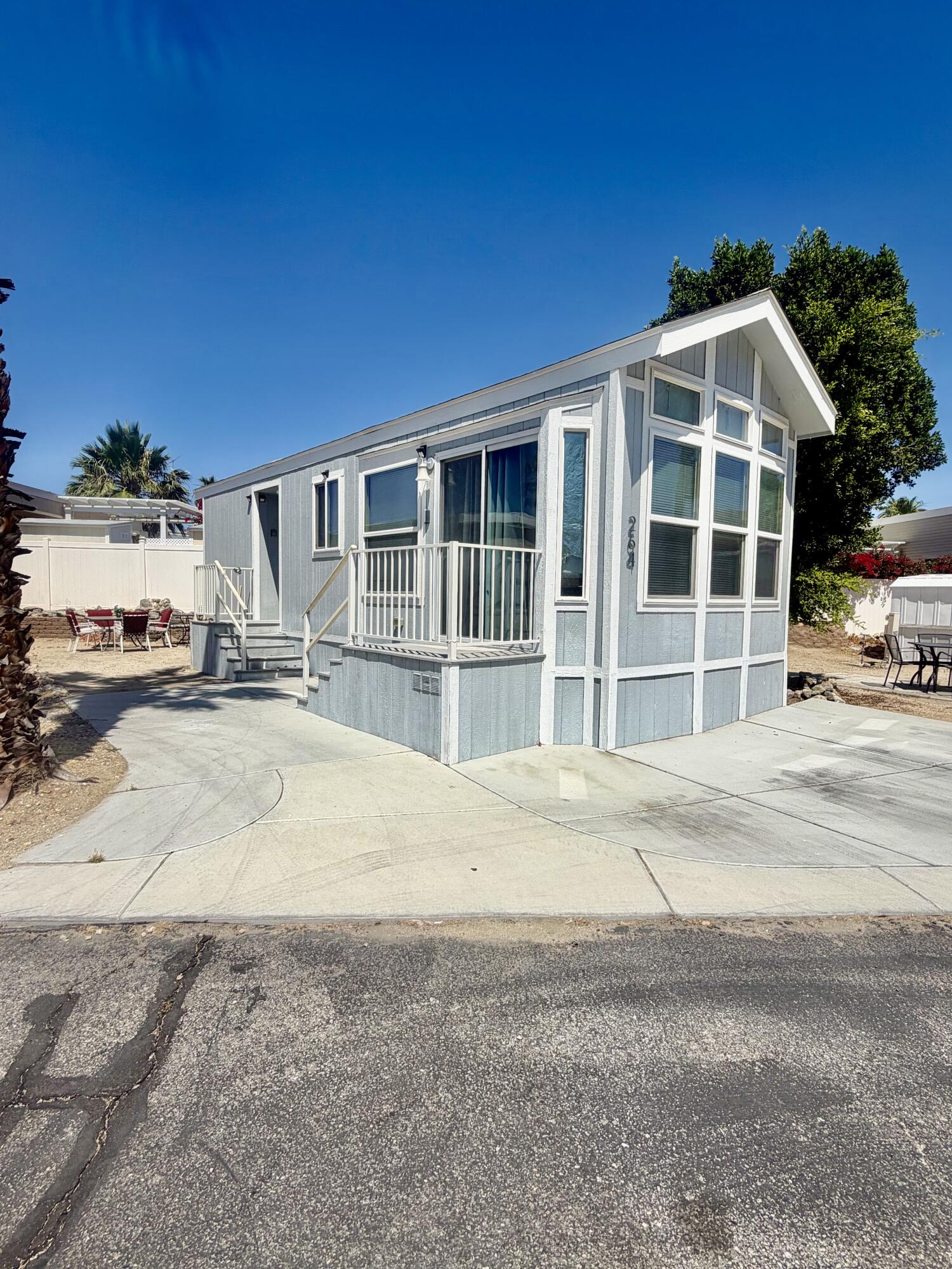 74711 Dillon Road, Unit 264 Desert Hot Springs, CA 92241 - Photo 1 of 21 a front view of a house with a yard