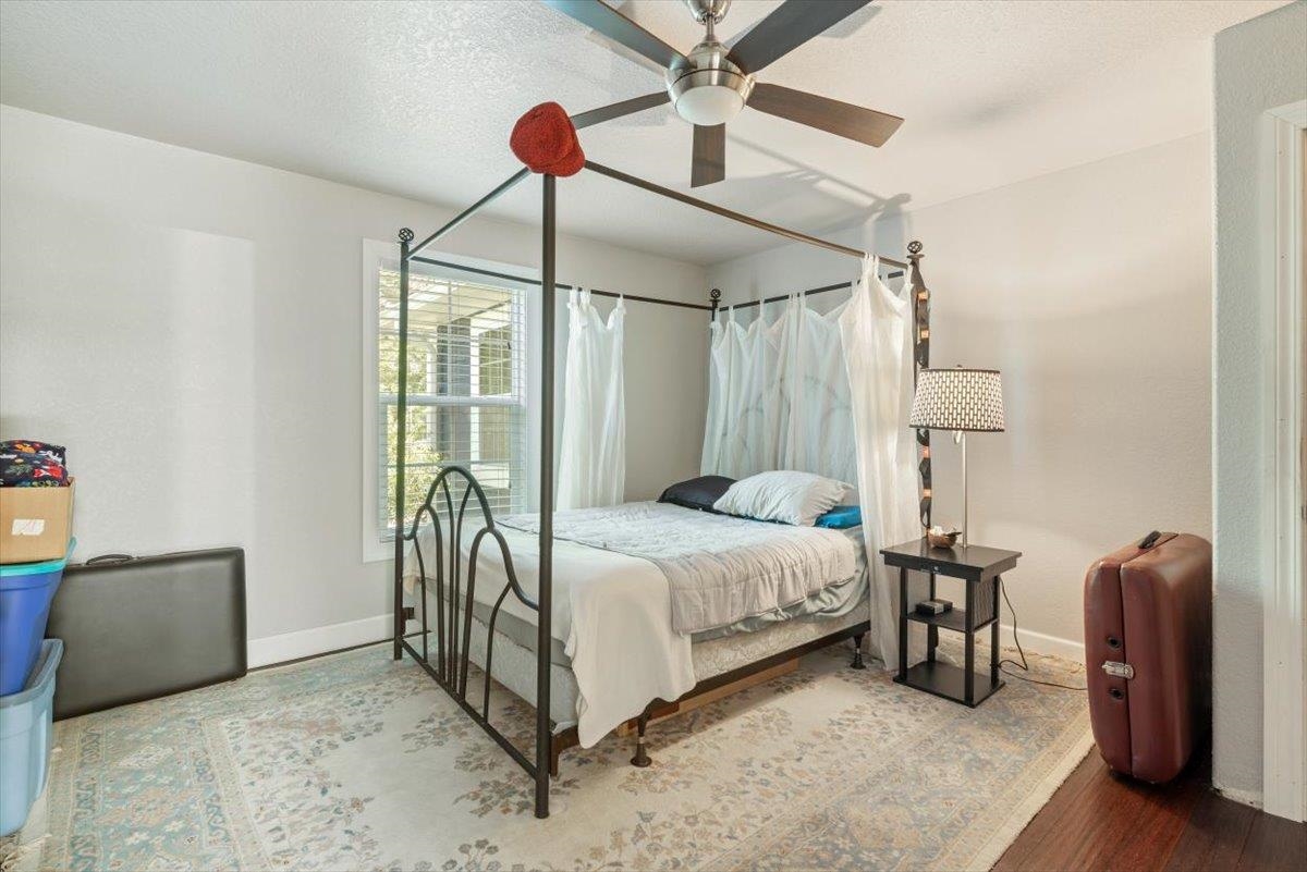 6342 Salado Road St. Augustine, FL 32080 - Photo 29 of 74 a bedroom with a bed and a chandelier