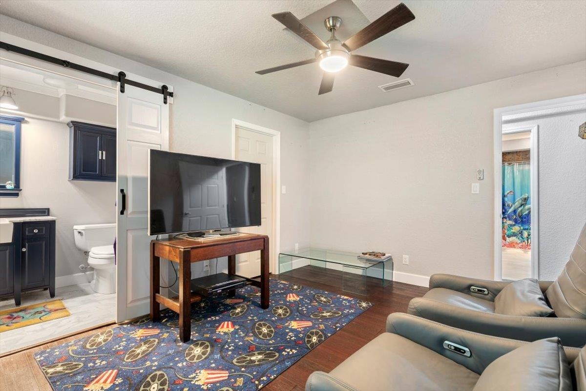 6342 Salado Road St. Augustine, FL 32080 - Photo 36 of 74 a living room with furniture a flat screen tv and kitchen view