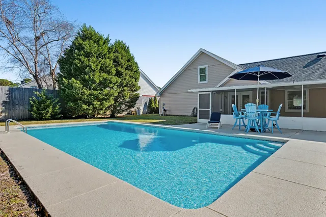 a view of house with garden and tall buildings