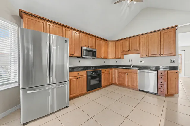 an aerial view of a houses with a swimming pool