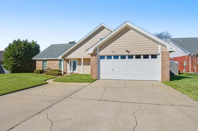 a kitchen with granite countertop a refrigerator and a stove top oven