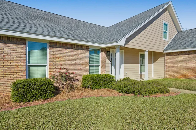 a view of an empty room with a floor to ceiling window and an entryway