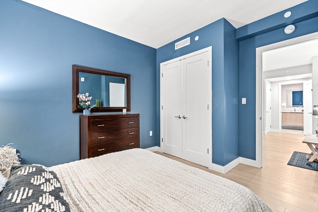 932 Broadway, Unit 208 Chelsea, MA 02150 - Photo 14 of 24 a bedroom with a bed and a dresser