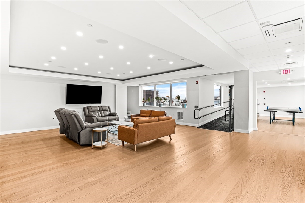 932 Broadway, Unit 208 Chelsea, MA 02150 - Photo 19 of 24 a living room with furniture flat screen tv and a table