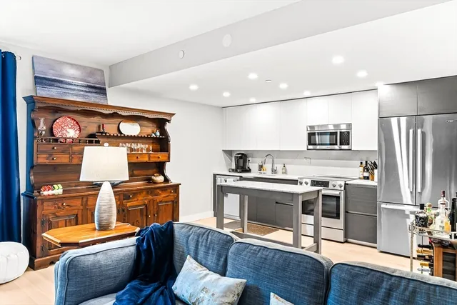 a kitchen with stainless steel appliances granite countertop a stove and a refrigerator