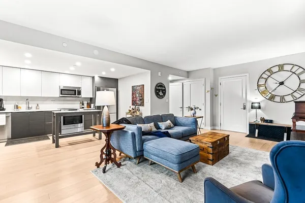 a living room with furniture and kitchen view
