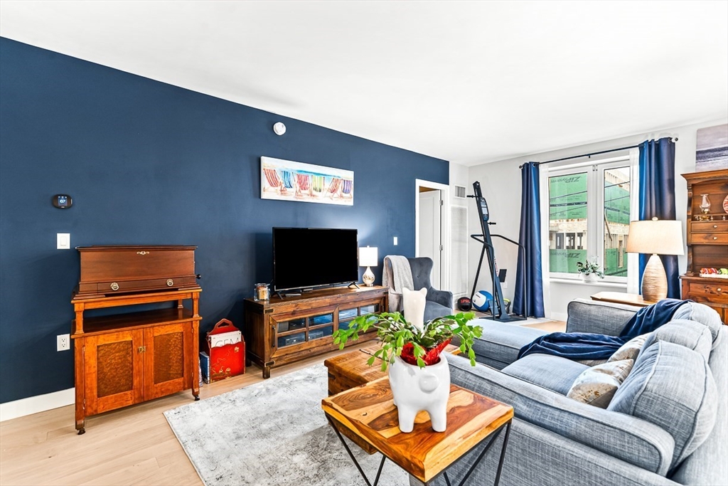 932 Broadway, Unit 208 Chelsea, MA 02150 - Photo 9 of 24 a living room with furniture and a flat screen tv
