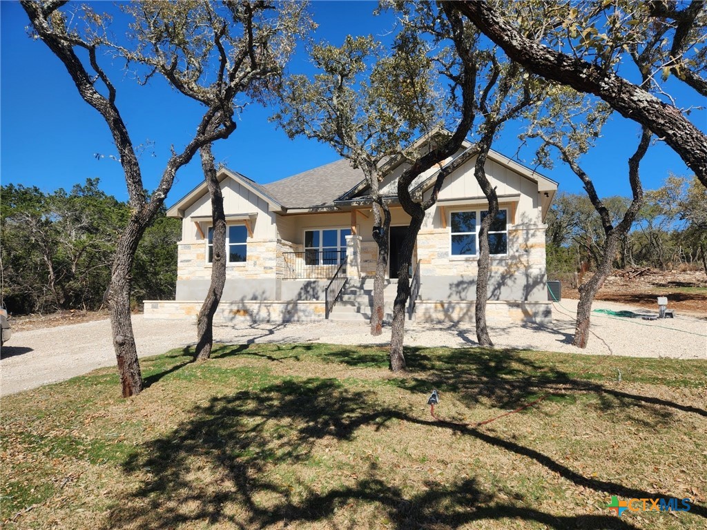 2587 Puter Creek Road Spring Branch, TX 78070 - Photo 1 of 1 a house that has a tree in front of it