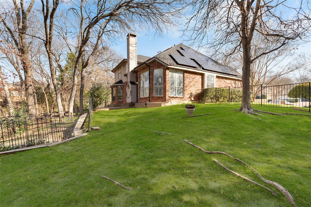 225 Freedom Court Rockwall, TX 75032 - Photo 23 of 28 a view of a white house with a big yard and large trees