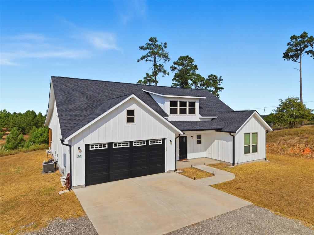 152 Spring Hollow Trail Smithville, TX 78957 - Photo 14 of 17 a front view of a house with a yard and garage