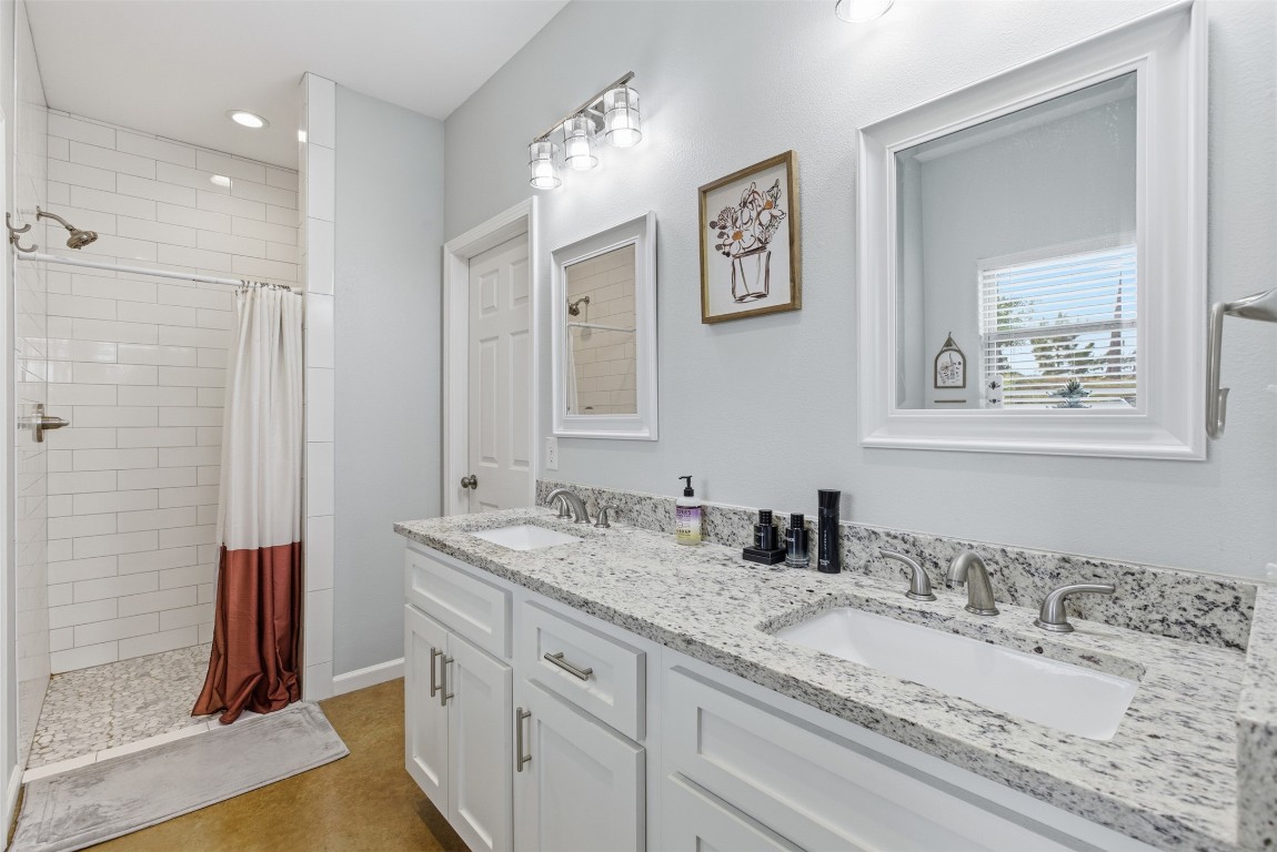 152 Spring Hollow Trail Smithville, TX 78957 - Photo 5 of 17 a bathroom with a granite countertop sink mirror and double