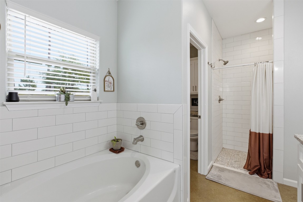 152 Spring Hollow Trail Smithville, TX 78957 - Photo 6 of 17 a bathroom with a bathtub and a shower