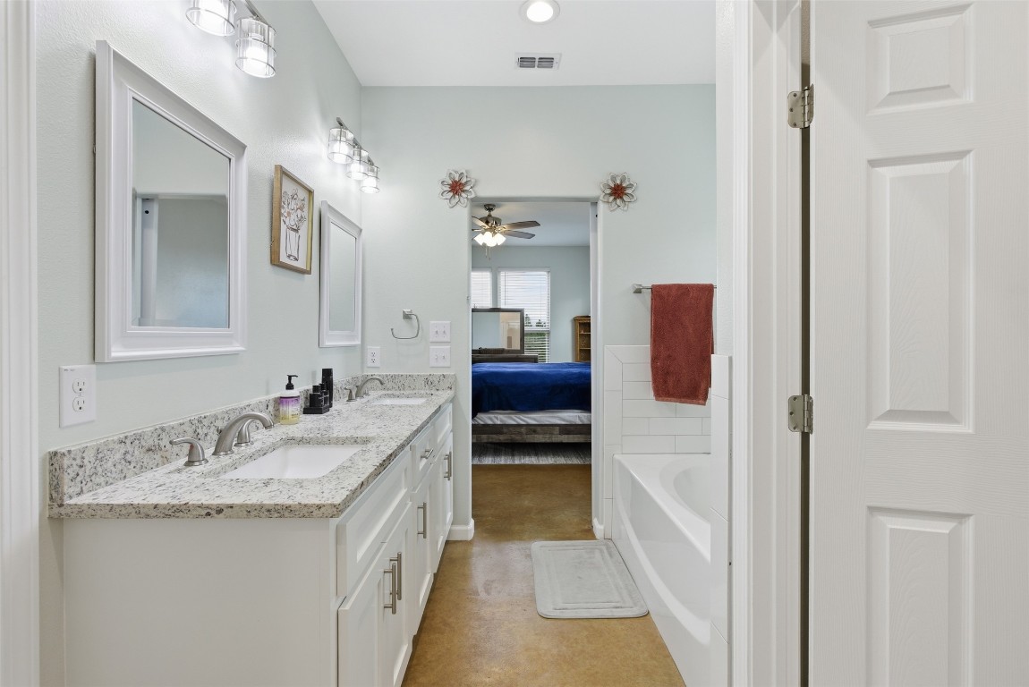 152 Spring Hollow Trail Smithville, TX 78957 - Photo 7 of 17 a bathroom with a granite countertop sink and a mirror