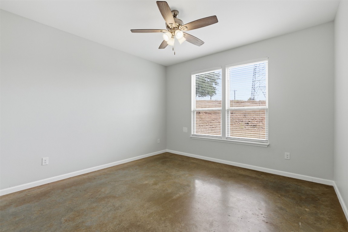 152 Spring Hollow Trail Smithville, TX 78957 - Photo 9 of 17 an empty room with a window and a ceiling fan