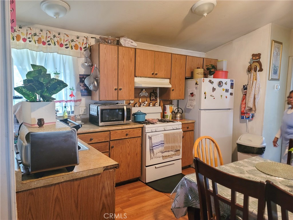 2500 North State Highway 59, Unit 278 Merced, CA 95348 - Photo 17 of 30 a kitchen with stainless steel appliances a stove refrigerator sink and cabinets
