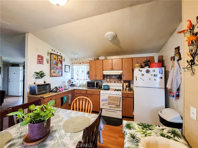 a kitchen with granite countertop a sink stove and refrigerator