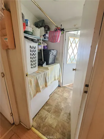 a view of a bedroom with baby crib and furniture