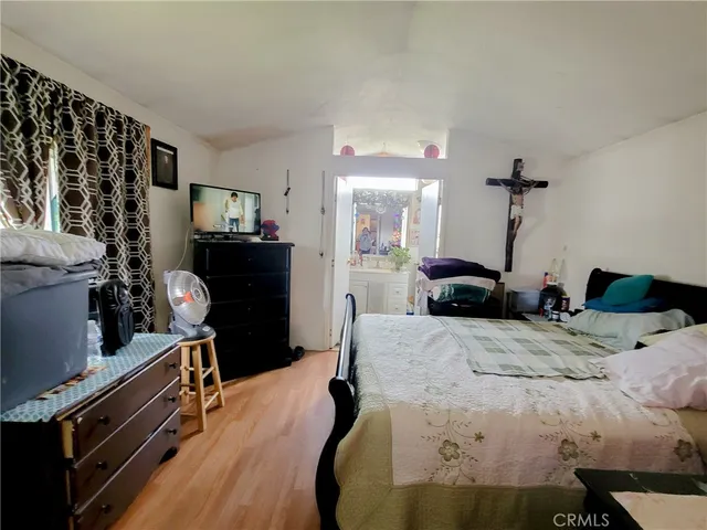 a bed room with a bed and a tv