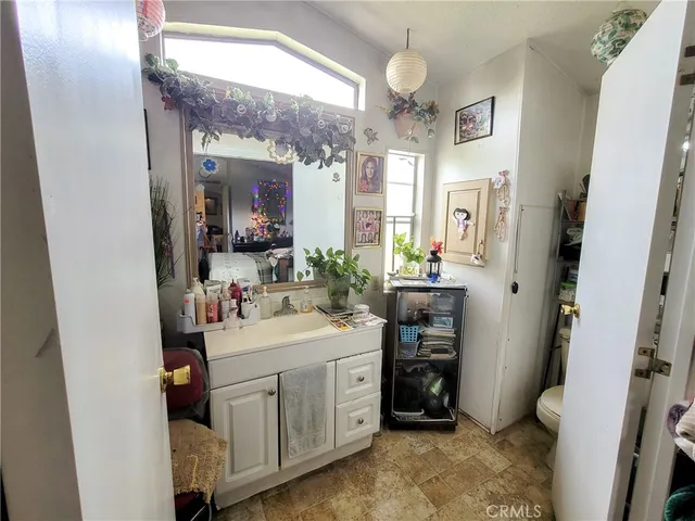a bathroom with a sink vanity and a mirror