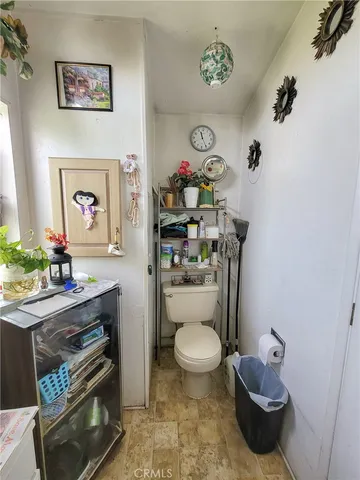 a bathroom with a toilet a sink and a mirror