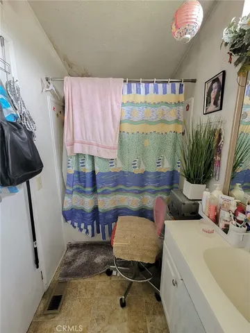 a reading room with furniture and a potted plant