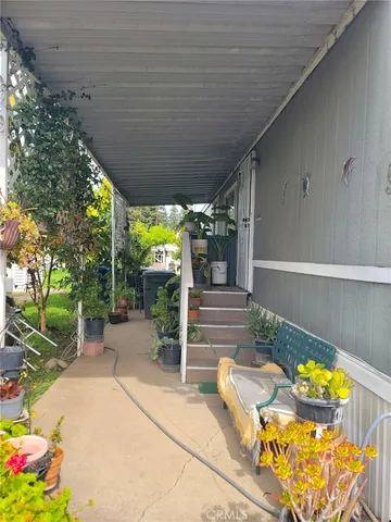 a view of a patio with table and chairs potted plants with wooden fence