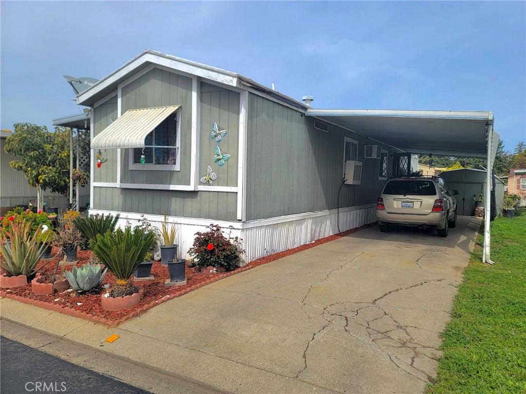 2500 North State Highway 59, Unit 278 Merced, CA 95348 - Photo 8 of 30 a front view of a house with a yard and garage