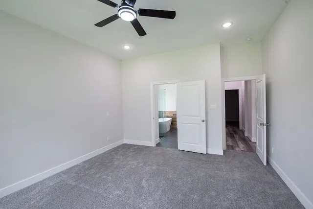 a bathroom with a granite countertop sink a toilet a mirror and shower
