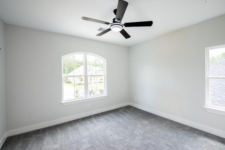 216 Monterrey Road West Montgomery, TX 77356 - Photo 19 of 26 an empty room with a window and a fan