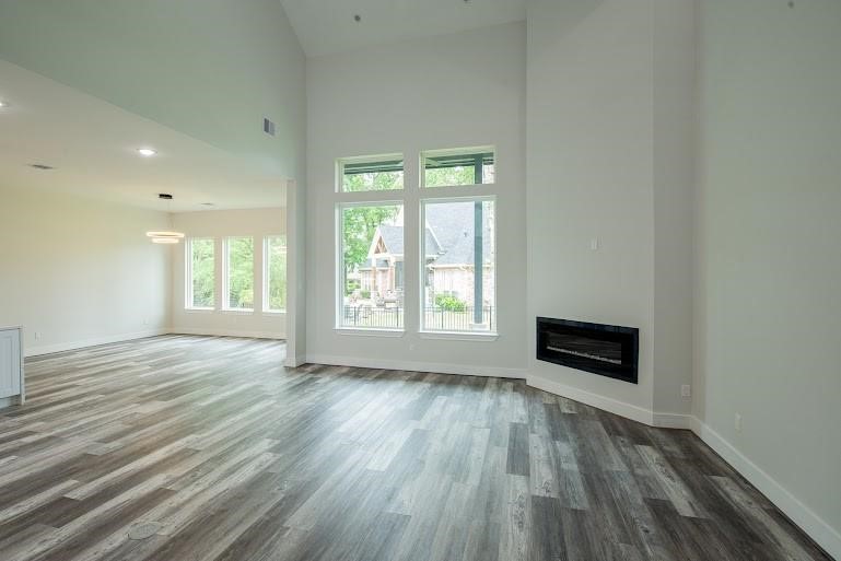 216 Monterrey Road West Montgomery, TX 77356 - Photo 5 of 26 an empty room with wooden floor and windows