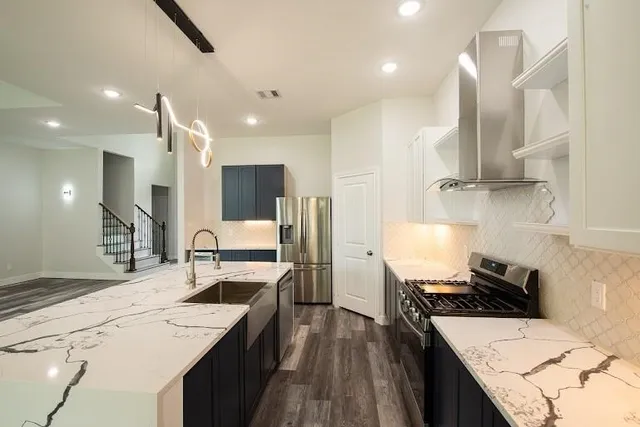 a kitchen with a sink stove and refrigerator