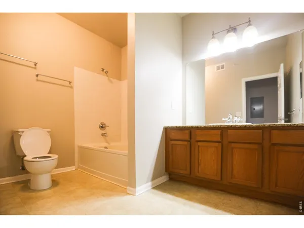 a bathroom with a sink vanity granite and a mirror