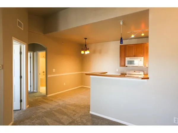 a kitchen with a sink a stove and cabinets