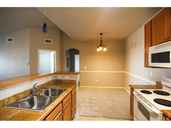 a kitchen with stainless steel appliances kitchen island granite countertop a sink and cabinets