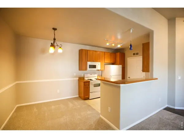 a kitchen with a stove a sink and a refrigerator