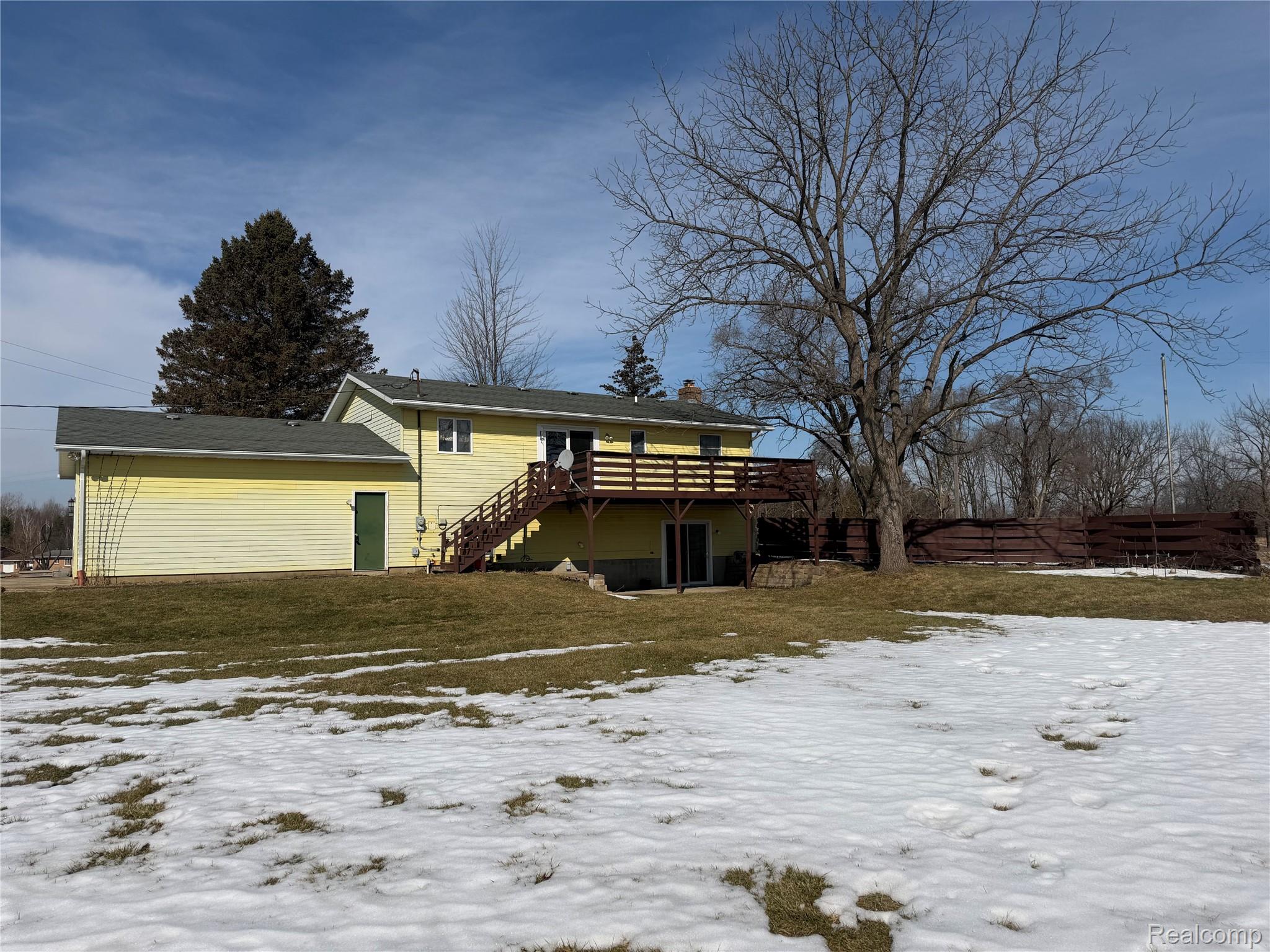 5749 Leix Road Mayville, MI 48744 - Photo 15 of 44 Snow covered rear of property featuring a wooden deck and a chimney