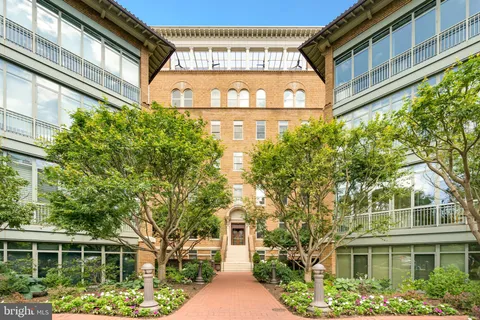 a front view of a building with a garden