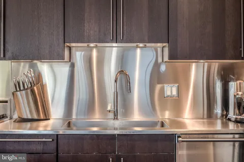 a view of kitchen with stainless steel appliances granite countertop and a refrigerator