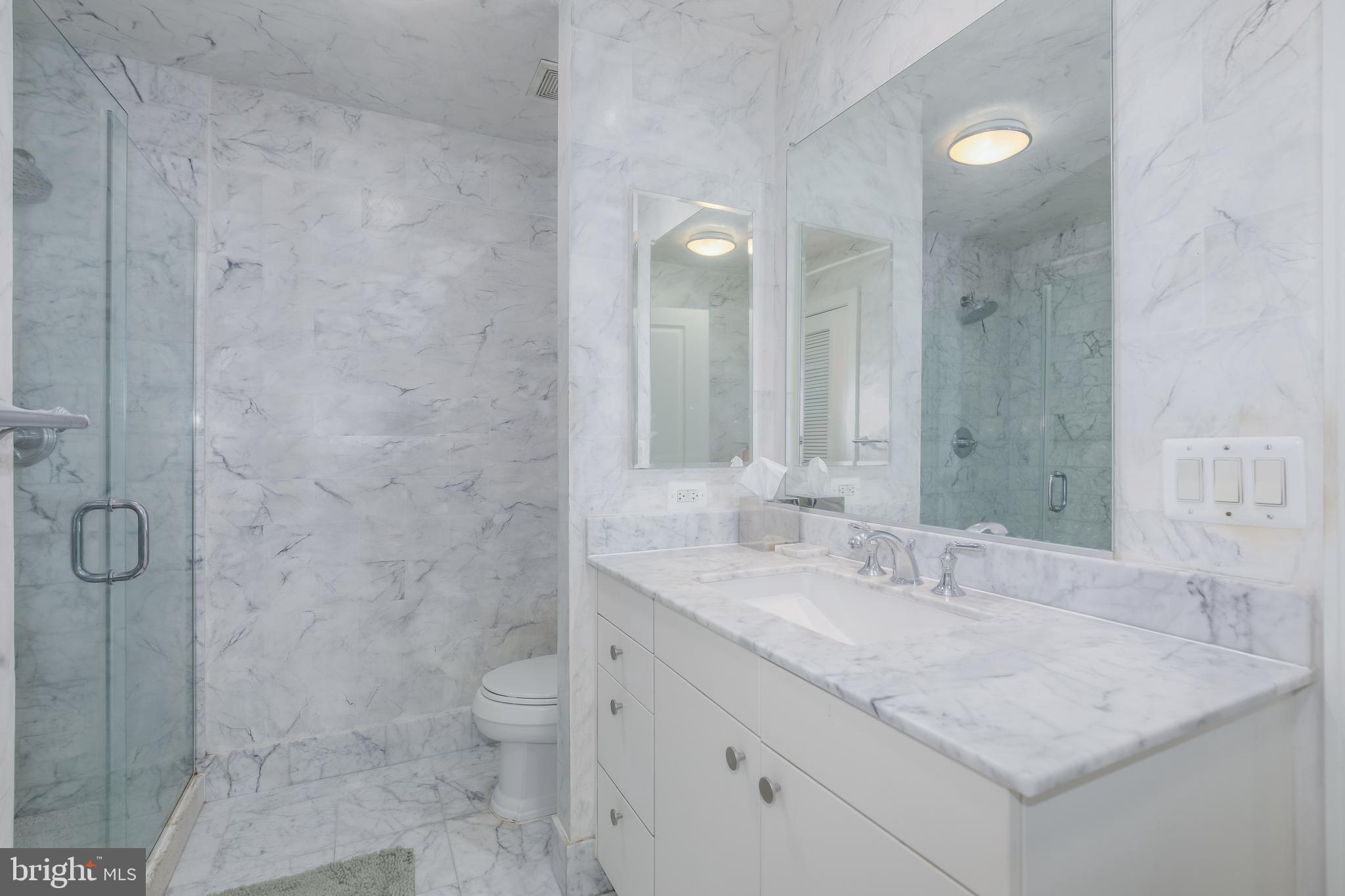 2425 L Street Northwest, Unit 211 Washington, DC 20037 - Photo 20 of 43 a bathroom with a granite countertop sink a toilet and shower