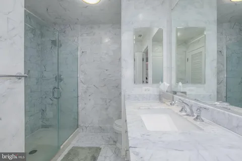 a bathroom with a toilet sink and shower