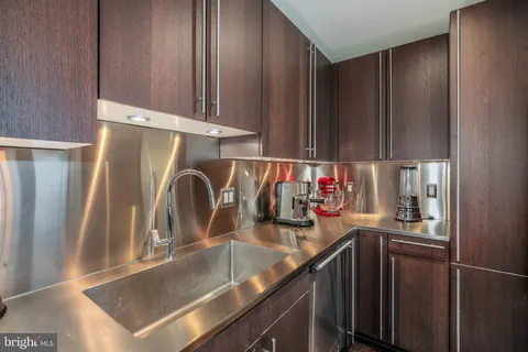 a kitchen with a sink and a refrigerator