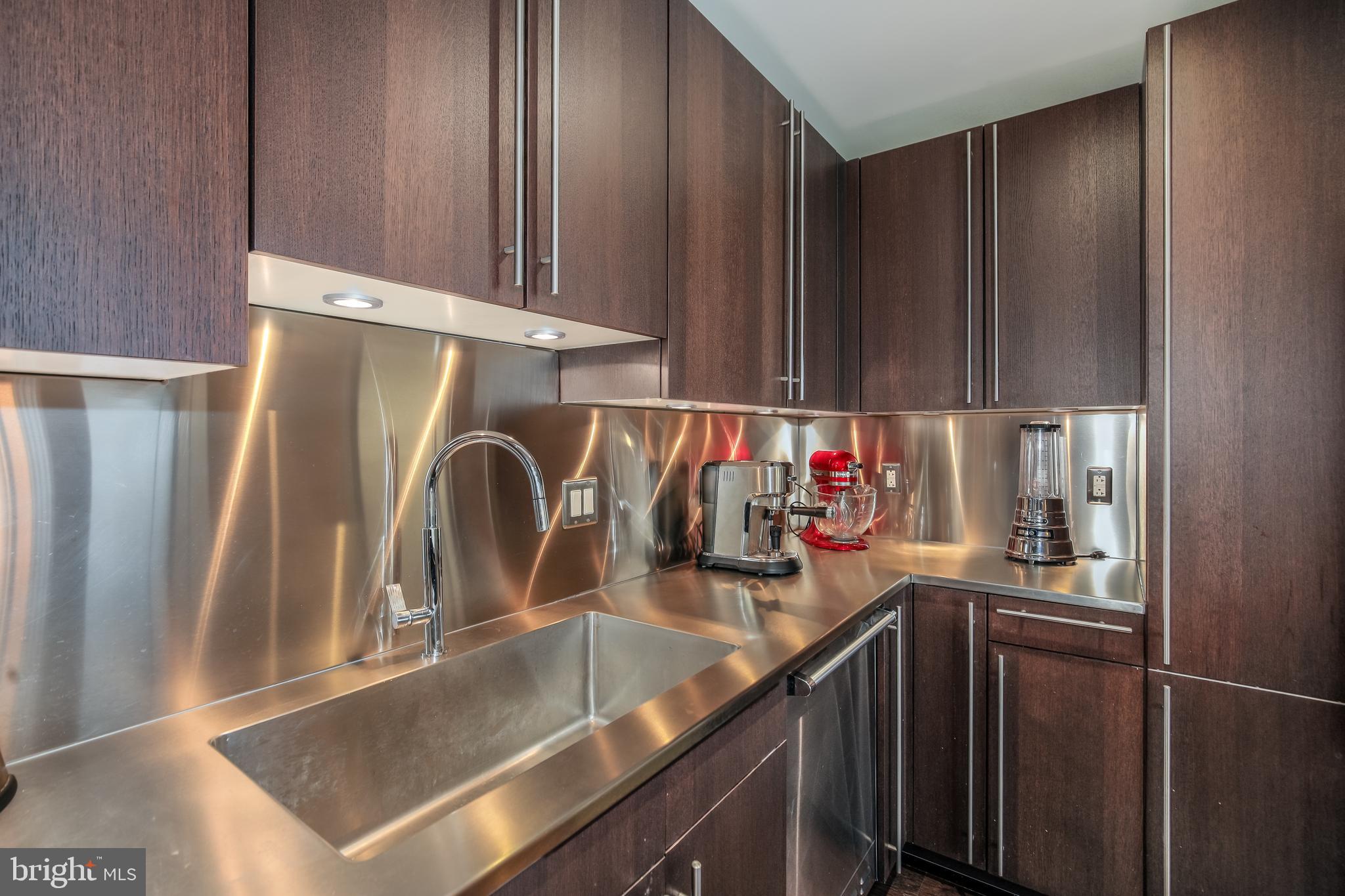 2425 L Street Northwest, Unit 211 Washington, DC 20037 - Photo 10 of 43 a kitchen with a sink and a refrigerator