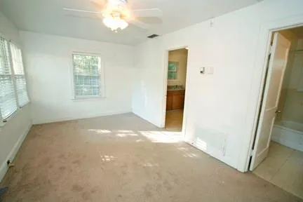 an empty room with windows and closet