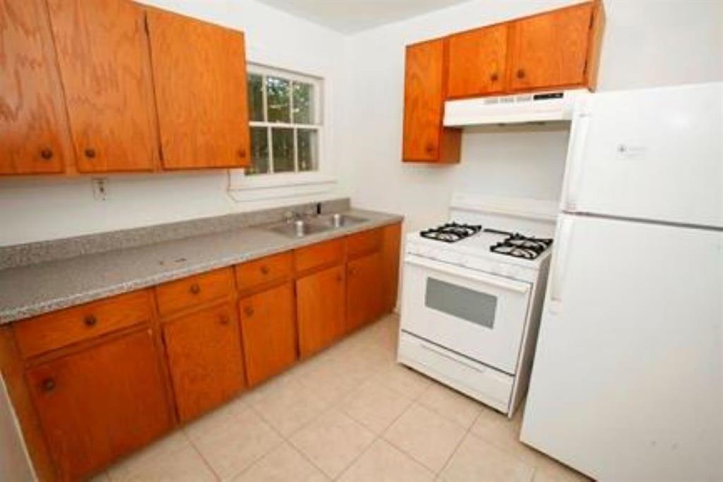 1020 Ellingson Lane, Unit B Austin, TX 78751 - Photo 3 of 6 a kitchen with stainless steel appliances a stove a microwave and a refrigerator