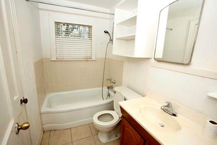 1020 Ellingson Lane, Unit B Austin, TX 78751 - Photo 6 of 6 a bathroom with a sink a toilet and a bathtub