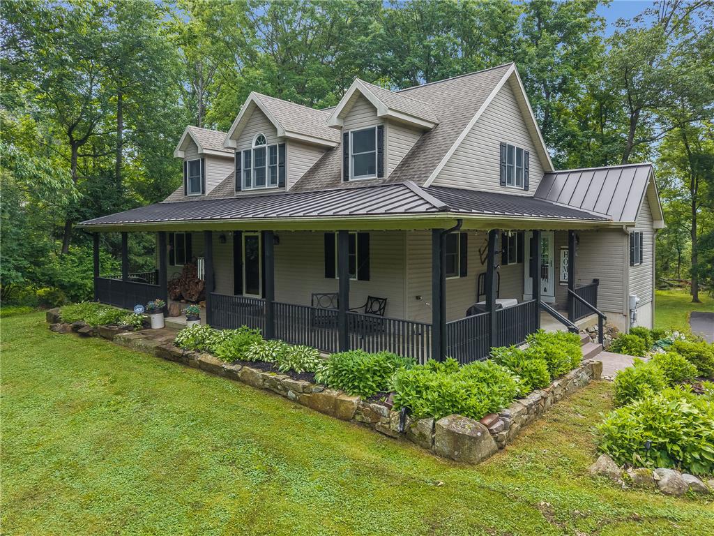 A welcoming front porch and mature landscaping enhance this charming residential exterior.